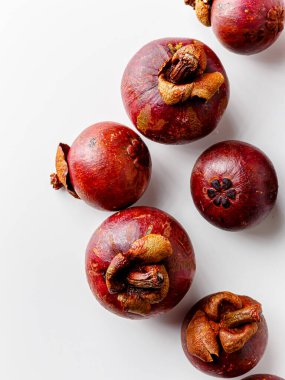 Mangosteens isolated on white background. Tropical fruits.