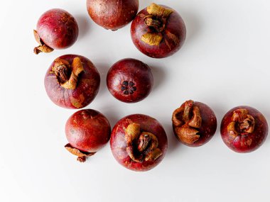 Mangosteens isolated on white background. Tropical fruits.