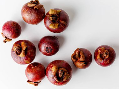 Mangosteens isolated on white background. Tropical fruits.