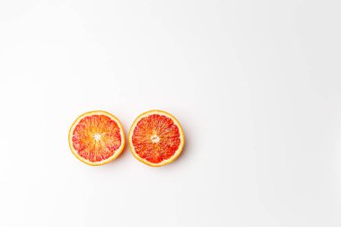 Red blood orange fruit with slices isolated on white background. Whole ripe juicy Sicilian Blood oranges. Selective focus. Isolated. Clipping path.