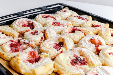 Puff pastry tart with raspberry and cream cheese mascarpone. Puff pastry cakes with cream filling and berry topping. Fresh delicious puff pastry with sweet berries. Close-up baked goods.