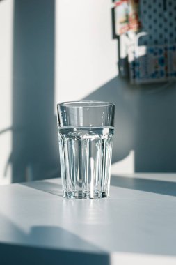 Glass of mineral filtered water and sunshine on white background including clipping path. 