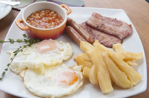 Eggs, sausage, аrench fries in white dish. — Stock Photo, Image