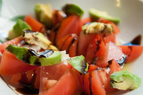 Tomatoes and avocados salad — Stock Photo, Image