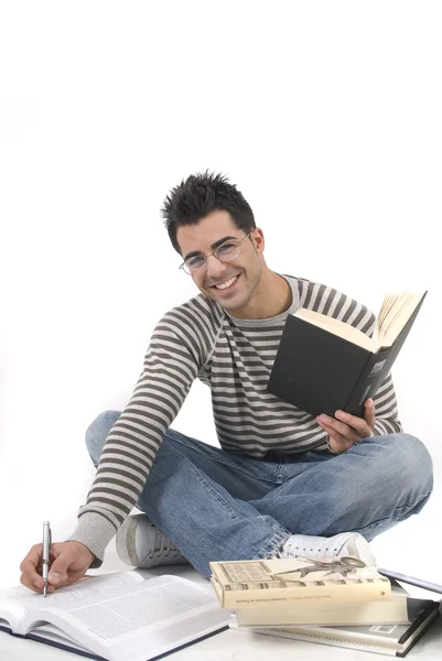 Young man sitting in the floor studying — Stock fotografie