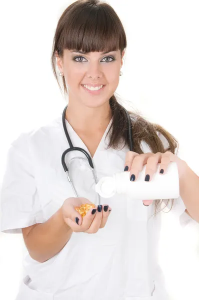 Lekarz, śmiejąc się z pigułki w jej ręce — Zdjęcie stockowe