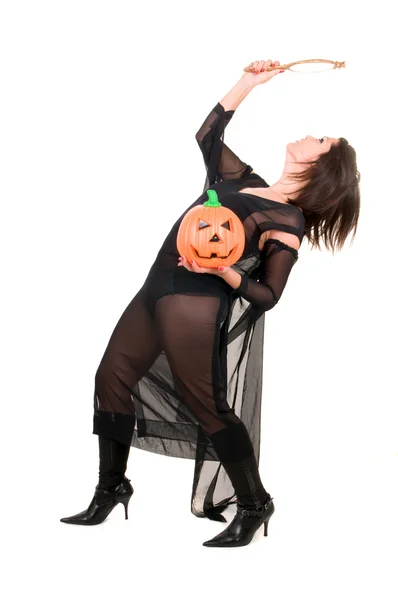 Mujer sexy bruja con calabaza de halloween —  Fotos de Stock