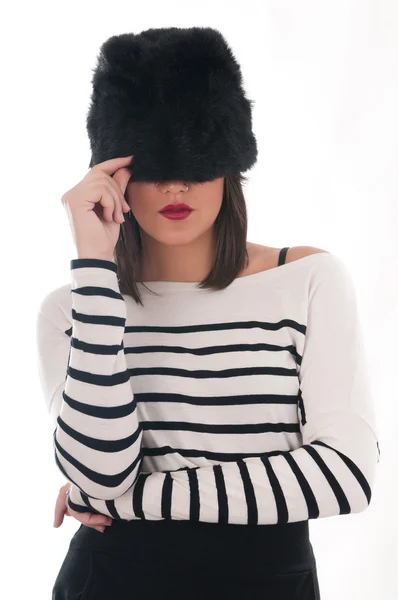Girl in a striped blouse and fur hat — Stock Photo, Image
