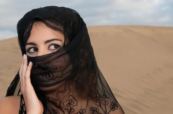 Woman in paranja in desert dunes — Stock Photo, Image