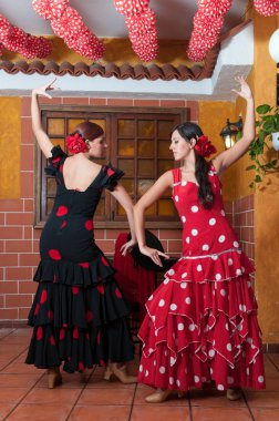 Traditional flamenco dresses dance during the Feria de Abril on April Spain clipart