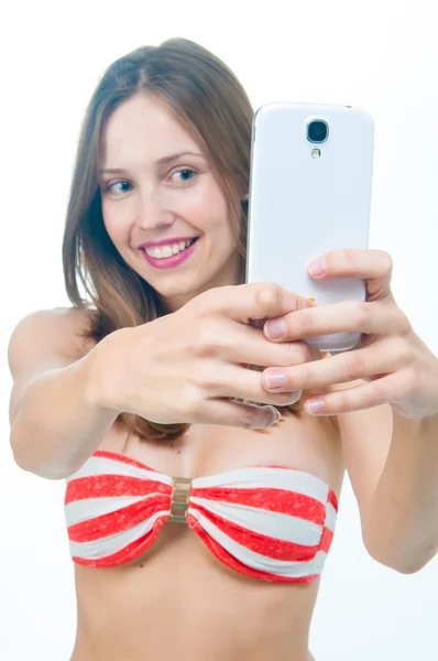 Beautiful woman in bikini  taking picture on her phone — Stock Photo, Image