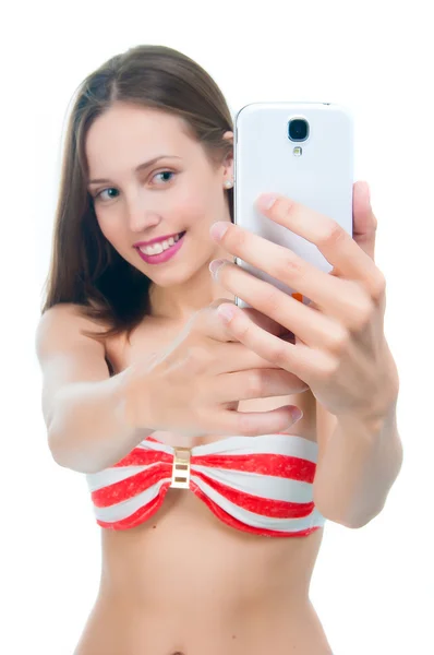 Beautiful woman in bikini  taking picture on her phone — Stock Photo, Image