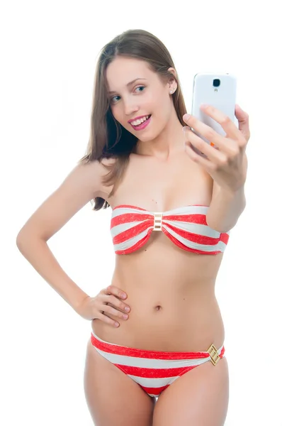 Beautiful woman in bikini  taking picture on her phone — Stock Photo, Image