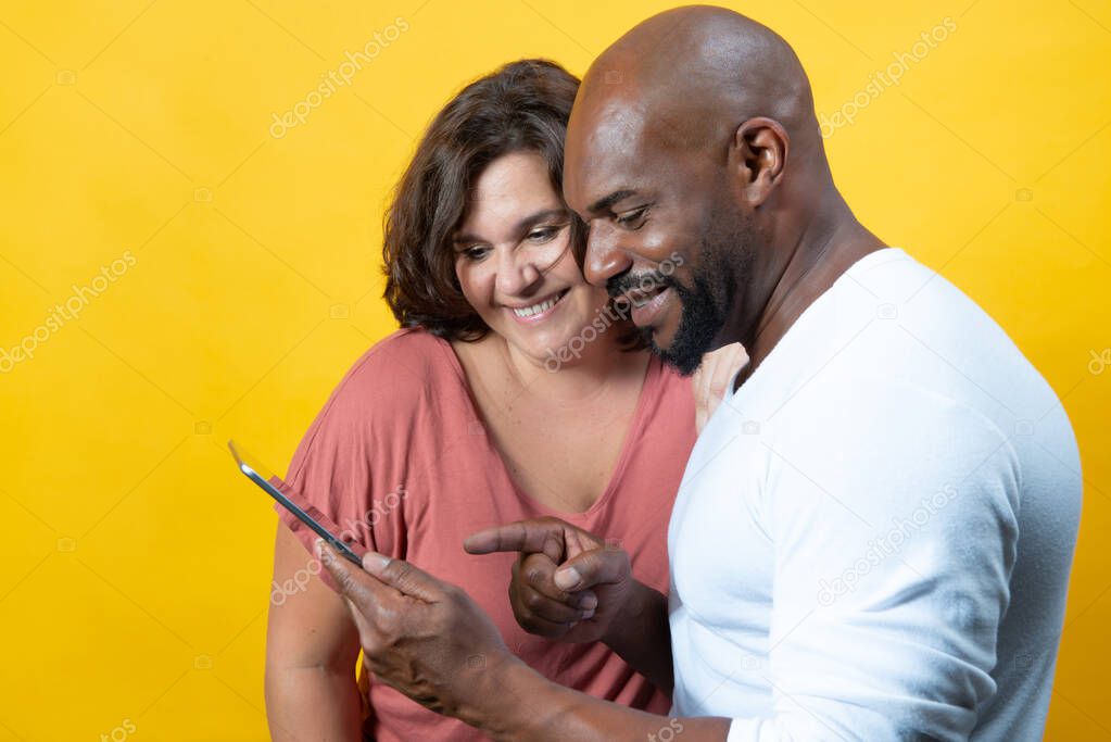 multiracial couple managing technology together 