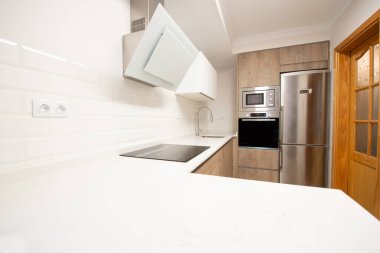 modern kitchen perfectly equipped with its appliances in a house