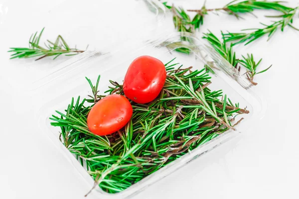 Organic pack of fresh rosemary with two tomato — Stock Photo, Image