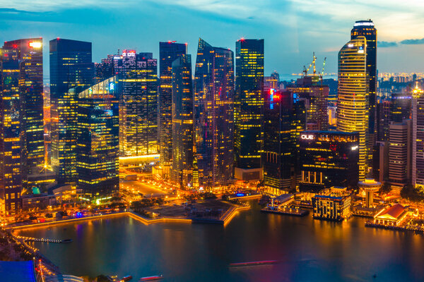 Singapore city skyline at night with blue sky
