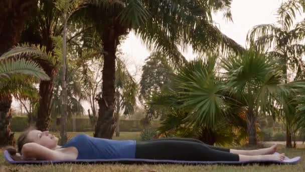 Angehende Fitness-Frau macht ABS-Übung auf Yoga-Matte im Stadtpark — Stockvideo