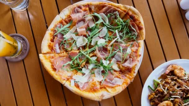 Man hand take piece of fresh baked pizza with parmesan cheese and prosciutto — Stock Video