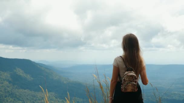 Inspirált utazó nő felemeli a karját, a hegy tetején áll — Stock videók