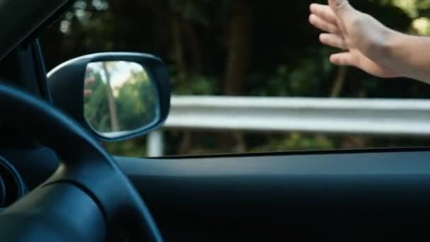 Беззаботный путешественник раздает и ловит ветер путешествия на машине и открывает окно — стоковое видео