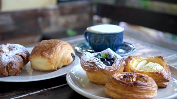 Sweet pastries in cafe. Puff pastry, fresh buns with powdered sugar and berries — Video Stock