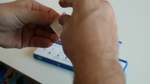 Man hands unpacking sterile nasal swab for antigen rapid test on Covid — стоковое видео
