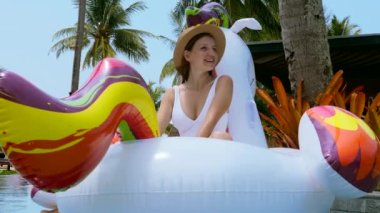 Lüks otel tropikal yüzme havuzunda tatilde mayo ve şapka takan mutlu turist. Tropikal yaz, Tayland 'da seyahat, turizm yaşam tarzı.
