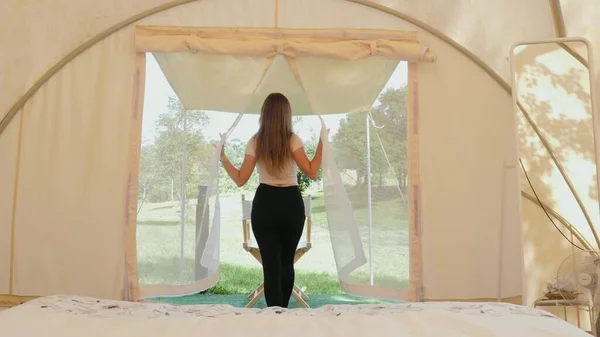 Travel camping woman walks to outside of tent to view on nature and wild animals — Stock Photo, Image