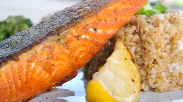 Close Fried Salmon Steak Vegetables Lemon Rice White Plate Healthy — Stock Video