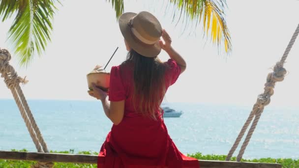 Back View Travel Woman Hat Young Coconut Hand Sitting Wooden — Stockvideo