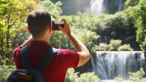 Young Man Traveler Make Photos Social Media Beautiful Exotic Waterfalls — 图库视频影像