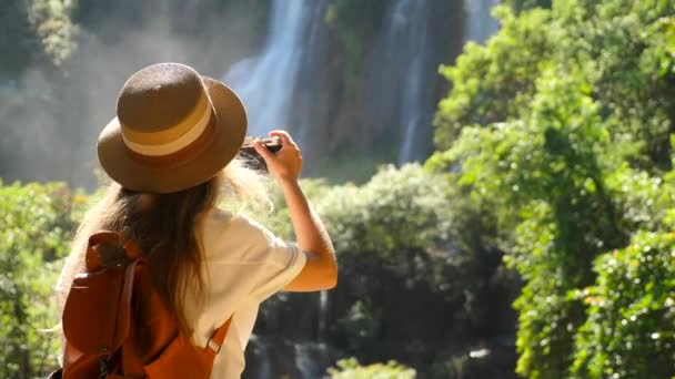 Back View Woman Photo Camera Shooting Tropical Waterfall Inspiring Millennial — Stock Video
