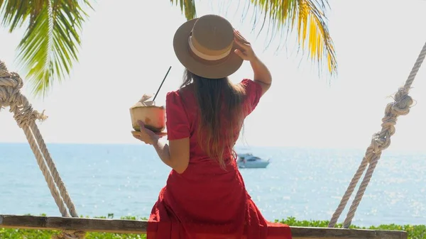 Beautiful Woman Hat Relaxing Swing Young Coconut Straw Beach Vacation — Zdjęcie stockowe