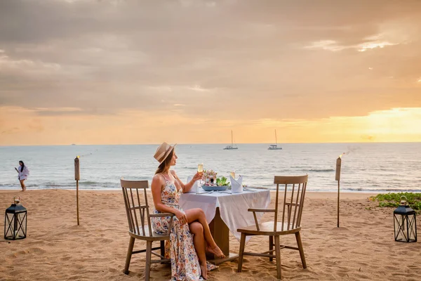 Romantic Date Sunset Beach Woman Sitting Alone Table Gourmet Food — Stockfoto