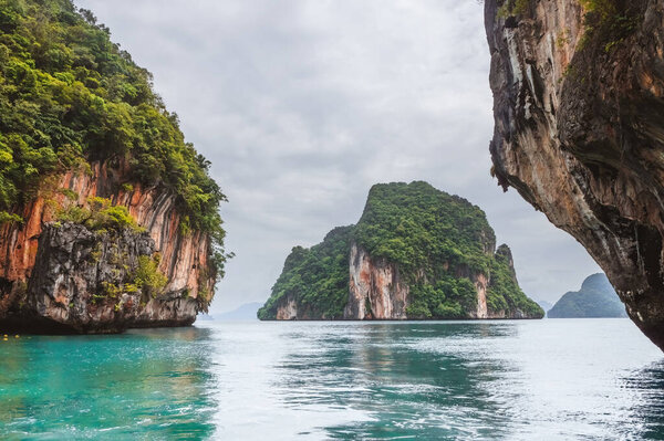 Limestone islands in Phang Nga Bay in Thailand. Amazed nature scenic view landscape. Trip in Asia islands. Popular tourist travel from Phuket or Krabi province in Thailand. Summer vacation trip