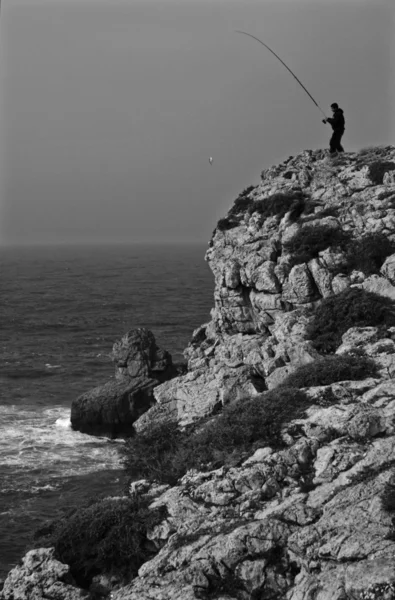 Uomo con pesce e canna da pesca — Foto Stock