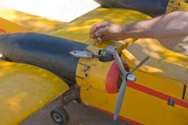 A man fixing his RC Hydroplane clipart