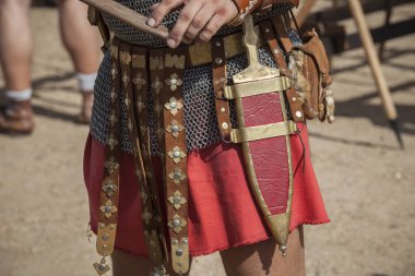Centurion girding a pugio, a dagger used by roman soldiers as a sidearm. Historical reenactment clipart