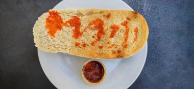 Iberian cachuela bread toast. Single-serve cachuela container