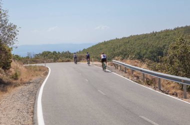 Cyclists speeding down the CC-139 winding road, Piornal, Caceres, Extremadura, Spain