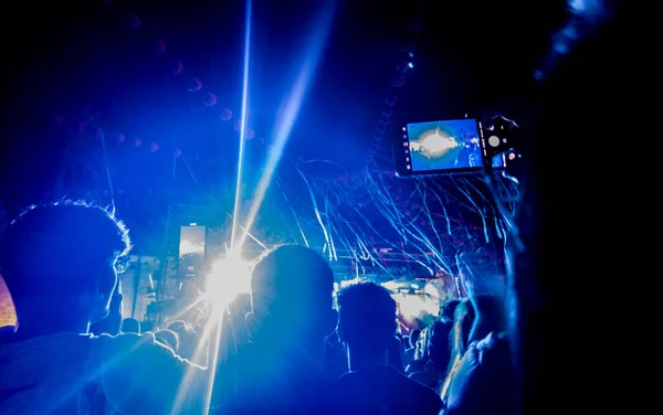 Live music performance decorated with paper lanterns and streamers. Backlight public view