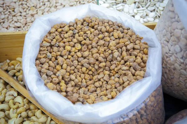 Rolled up sack full of tiger nuts or chufas. Displayed at street market stall