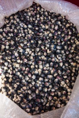 Bag of black corn seeds at Chichicastenango market Guatemala clipart