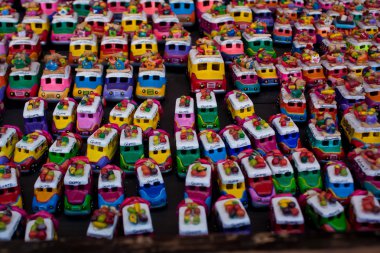 Toy chicken buses at Chichicastenango market Guatemala clipart