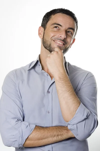 Glücklicher junger Mann mit Bart denkt isoliert weiß — Stockfoto