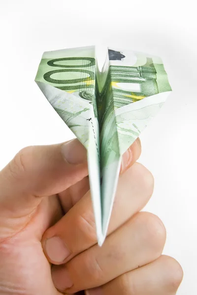 Hand met bankbiljet papier vliegtuig — Stockfoto