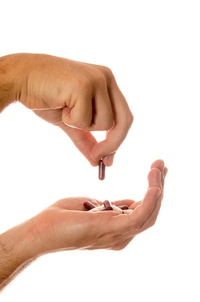 Masculino mão segurando pílulas — Fotografia de Stock