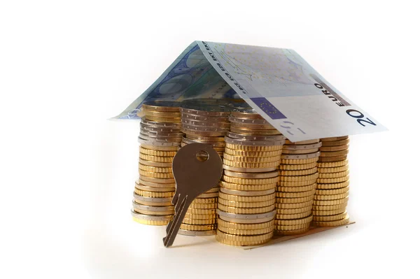 Euro Coins pile House with banknote roof and key — Stock Photo, Image