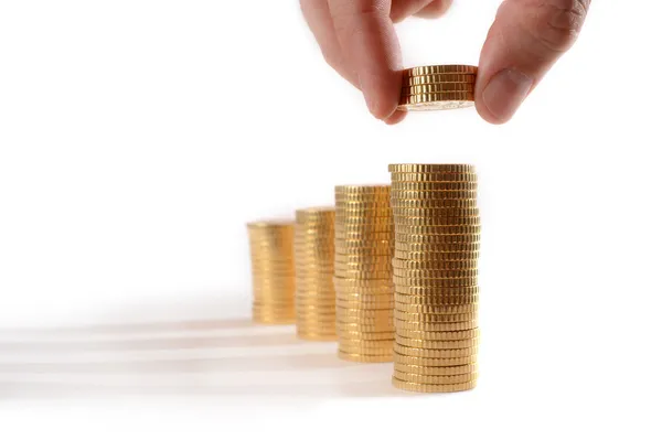 Male hand picking Euro Coins piled in stacks — Stock Photo, Image